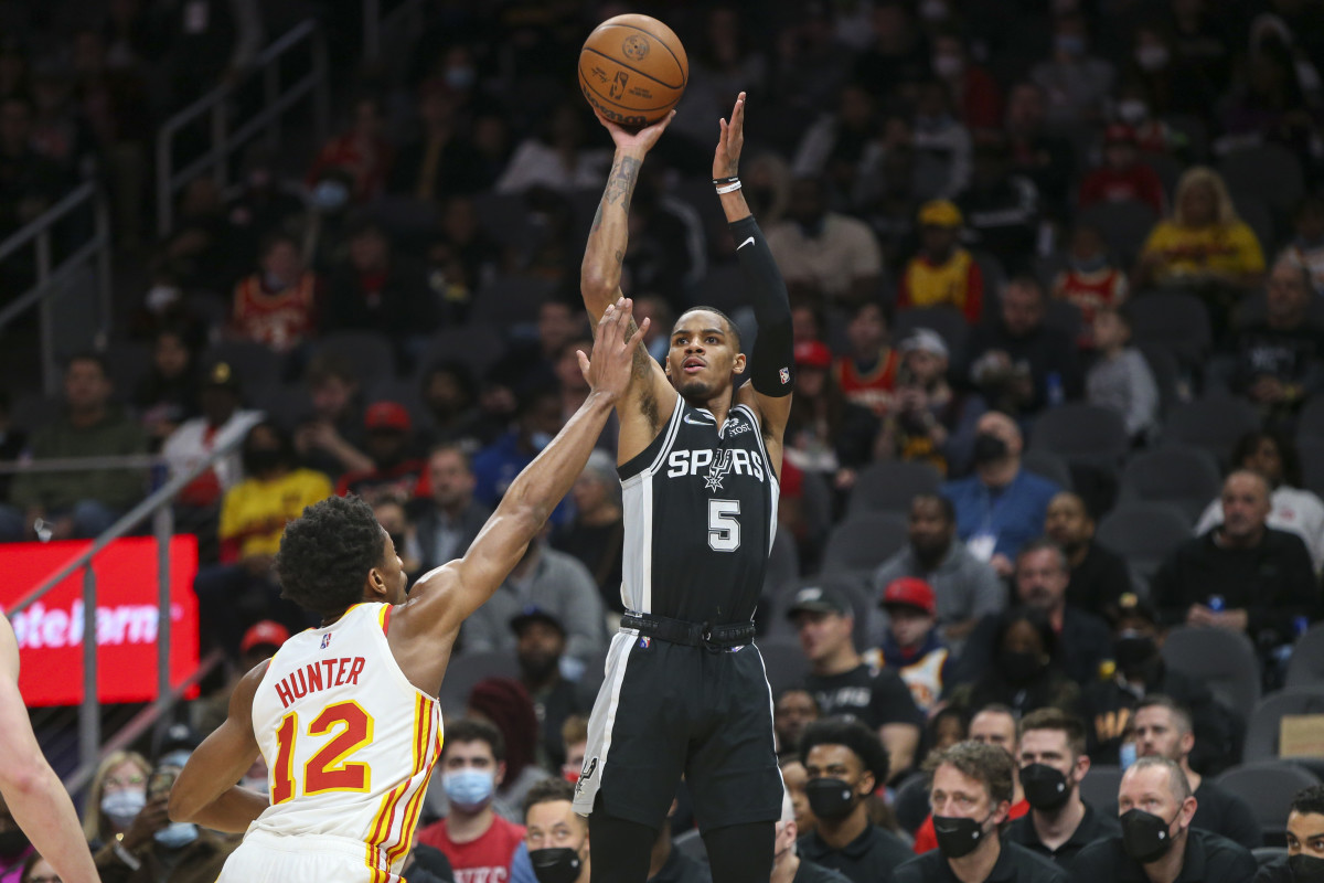 Feb 11, 2022; Atlanta, Georgia, USA; San Antonio Spurs guard Dejounte Murray (5) shoots over Atlanta Hawks forward De'Andre Hunter (12) in the first quarter at State Farm Arena.